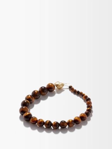 Bracelet perles en plaqué or et ail de tigre - Completedworks - Modalova