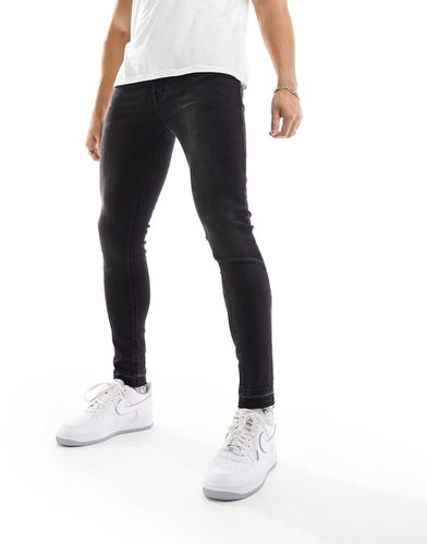 Jean seconde peau en tissu power stretch avec ourlets bruts - Asos Design - Modalova