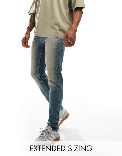 Jean skinny surteint - moyen délavé - Asos Design - Modalova