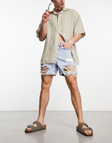 Short court en jean avec déchirures - moyen délavé - Asos Design - Modalova