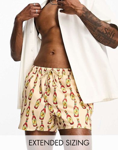 Short de bain court à imprimé sauce piquante - Asos Design - Modalova