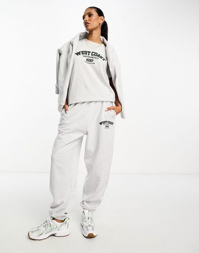 Pantalon de jogging d'ensemble oversize avec motif West Coast - Glace chiné - Asos Design - Modalova