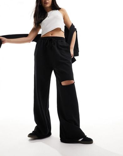 Pantalon de jogging large avec genou déchiré - Asos Design - Modalova