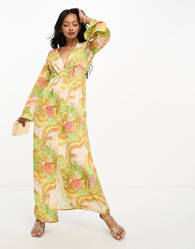 Robe plissée longue à décolleté plongeant et imprimé coucher de soleil tropical - Never Fully Dressed - Modalova