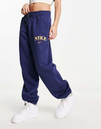 Athletics - Pantalon de jogging unisexe rétro en polaire - Bleu nuit et doré - Nike - Modalova