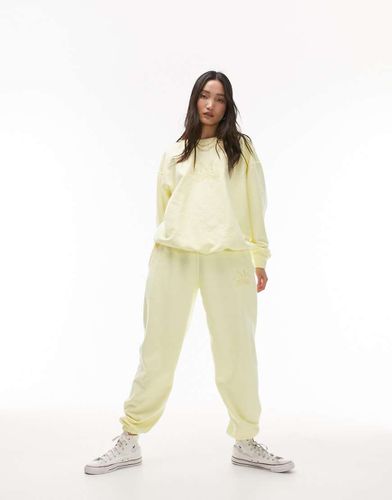 Jogger d'ensemble oversize resserré aux chevilles avec inscription East Mercer » brodée - délavé - Topshop - Modalova