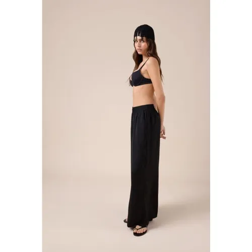 Pantalon palazzo brillant Taille M - Calzedonia - Modalova