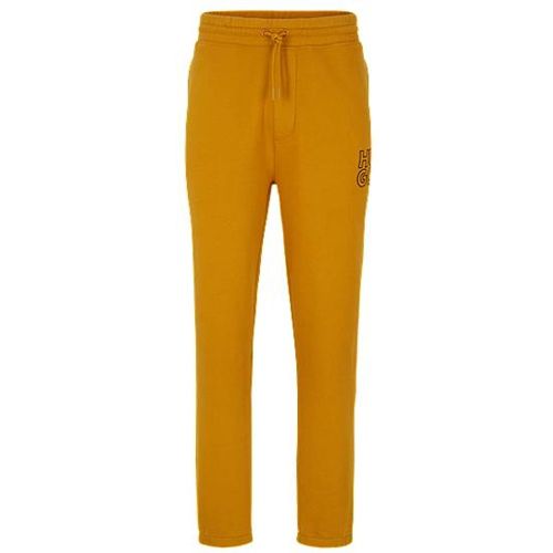 Pantalon de survêtement resserré au bas des jambes, en coton biologique à logo revisité - HUGO - Modalova