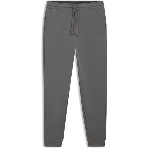 Bas de survêtement en molleton de coton avec logo imprimé et bas de jambes resserrés - HUGO - Modalova