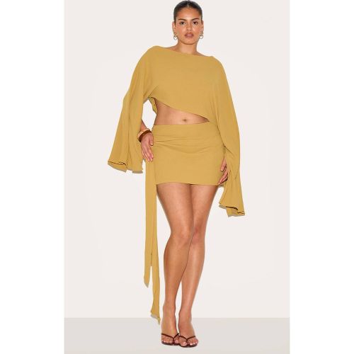 Mustard Jupe Mini En Tissu Fluide Avec Nœud Sur Le Côté Grande Taille | Taille 30 - PrettyLittleThing - Modalova
