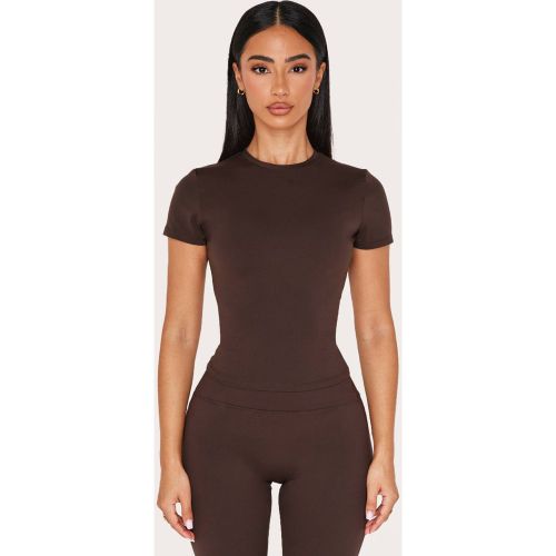 Haut De Sport À Manches Courtes Coupe Longue Sculptant Petite | Taille XS - PrettyLittleThing - Modalova